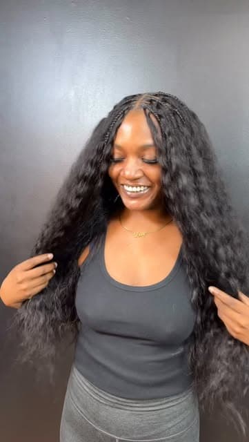 Client smiling, showing off long curly braided hair