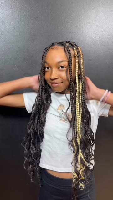 Child with long braids featuring blonde curled ends
