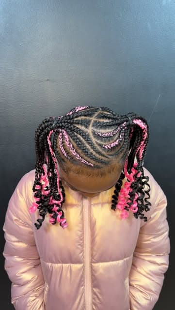 Child's braided pigtails with pink accent strands and curled ends